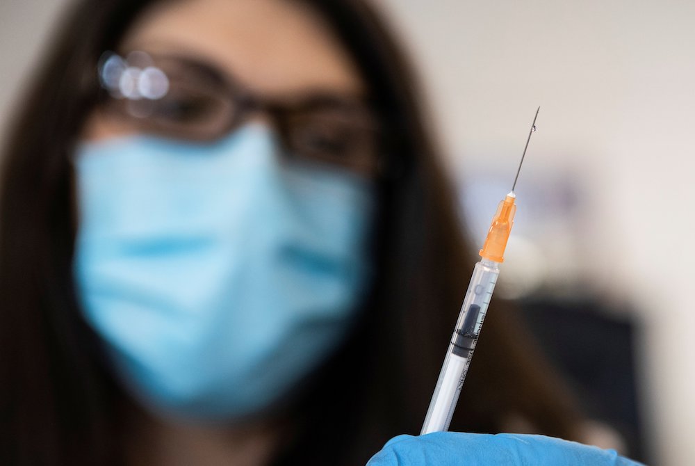 A nurse in Richmond, Virginia, readies a syringe with the COVID-19 vaccine at the Richmond Raceway complex March 4, 2021. (CNS/Reuters/Julia Rendleman) A nurse in Richmond, Virginia, readies a syringe with the COVID-19 vaccine at the Richmond Raceway complex March 4, 2021. (CNS/Reuters/Julia Rendleman)